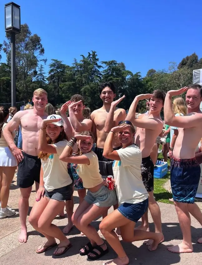 Brothers and friends striking a salute pose in the sun at DG Anchor Splash