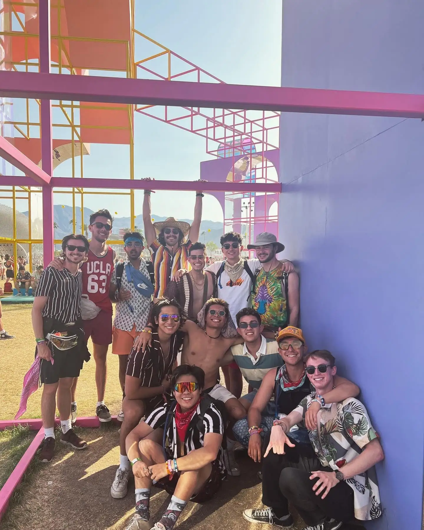 The group posed under a festival art structure